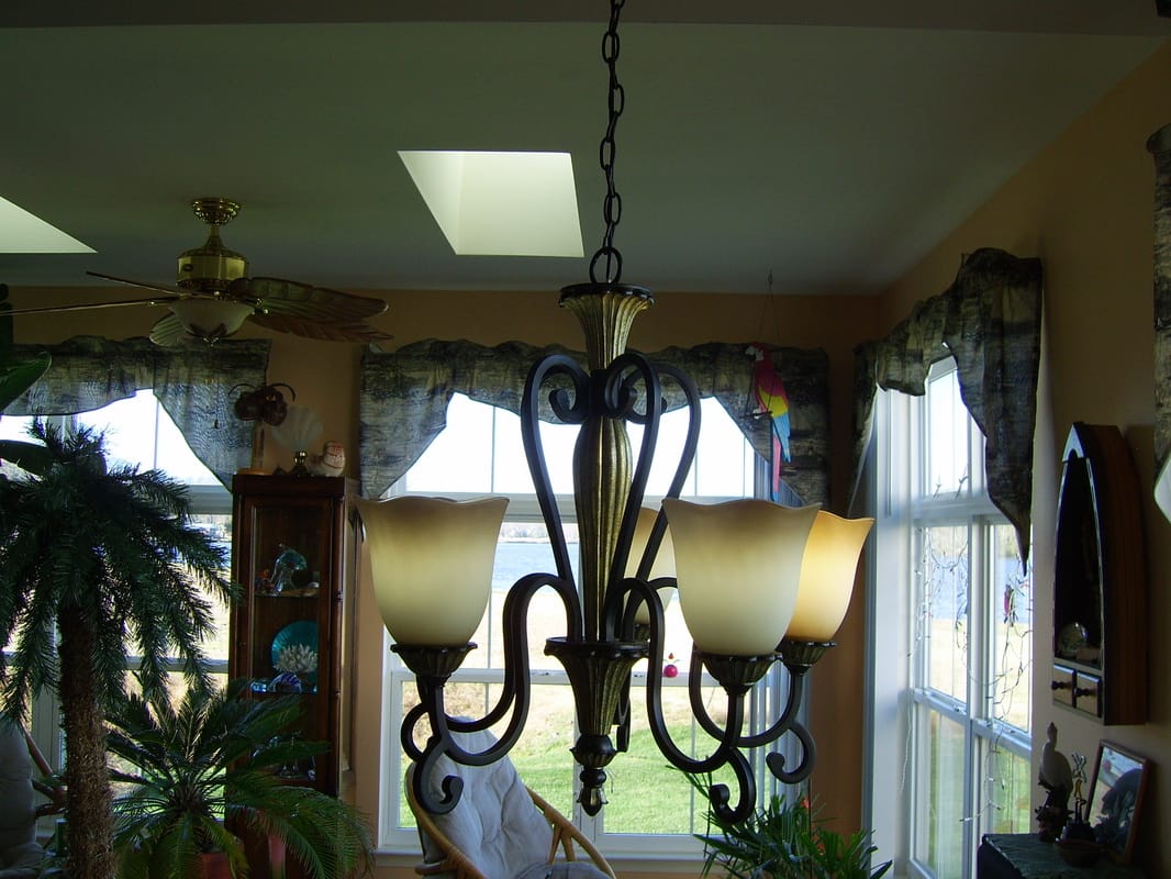Chandelier installed and lit over a dining area