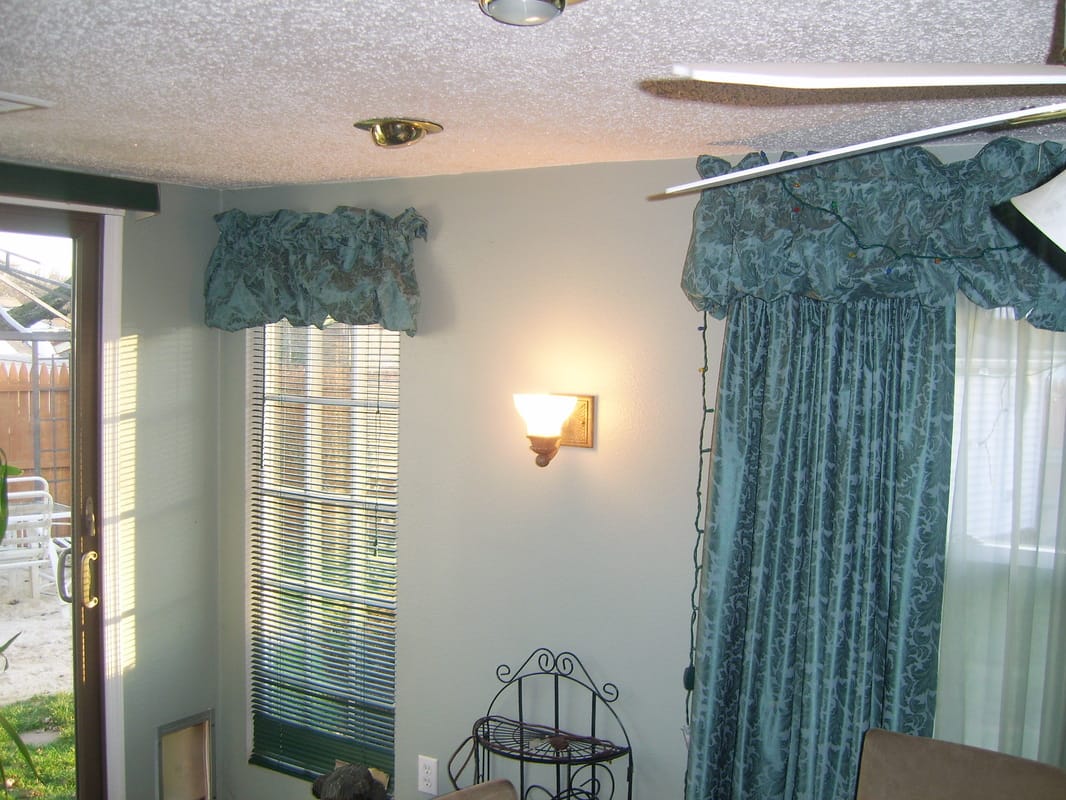Dining room with recessed ceiling lights and wall sconces