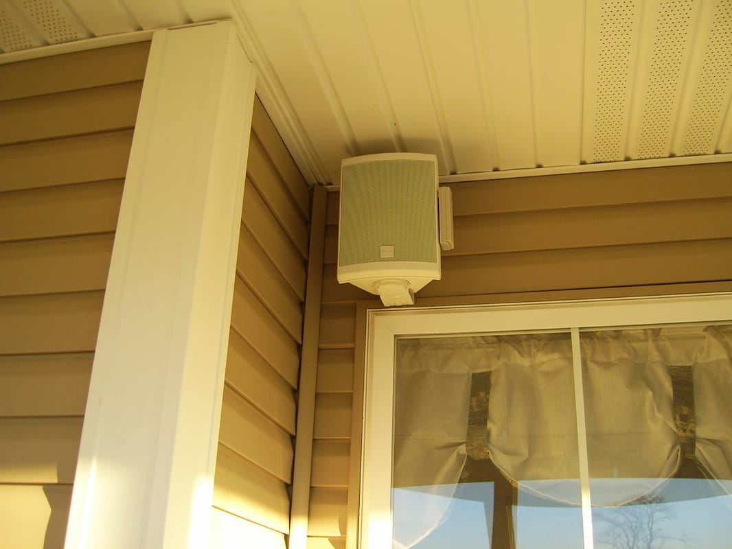 Outdoor speaker mounted on a porch