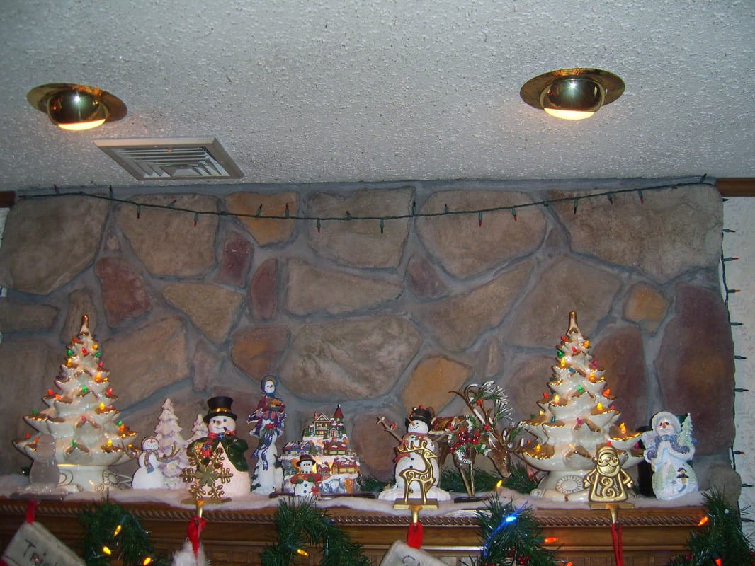Recessed lights installed above a fireplace